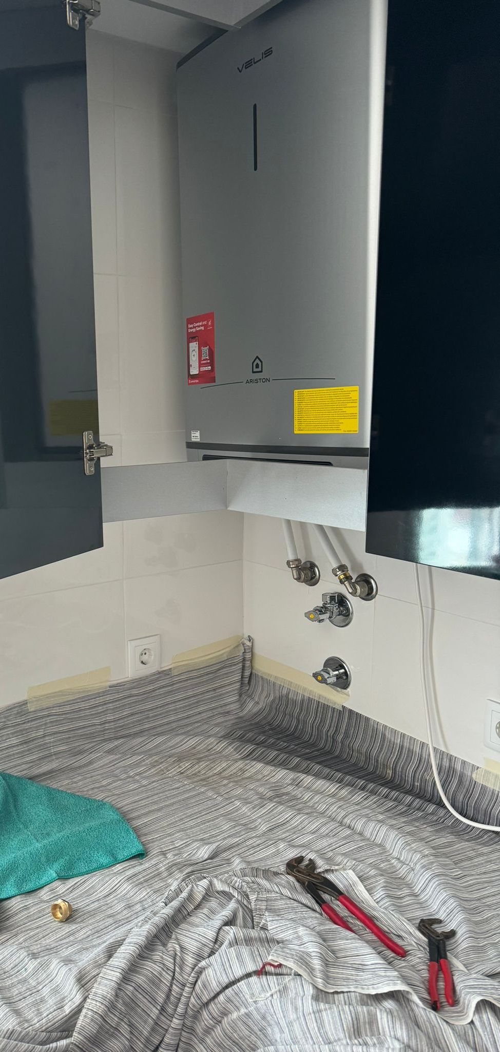 Gas boiler installation in kitchen cabinet space